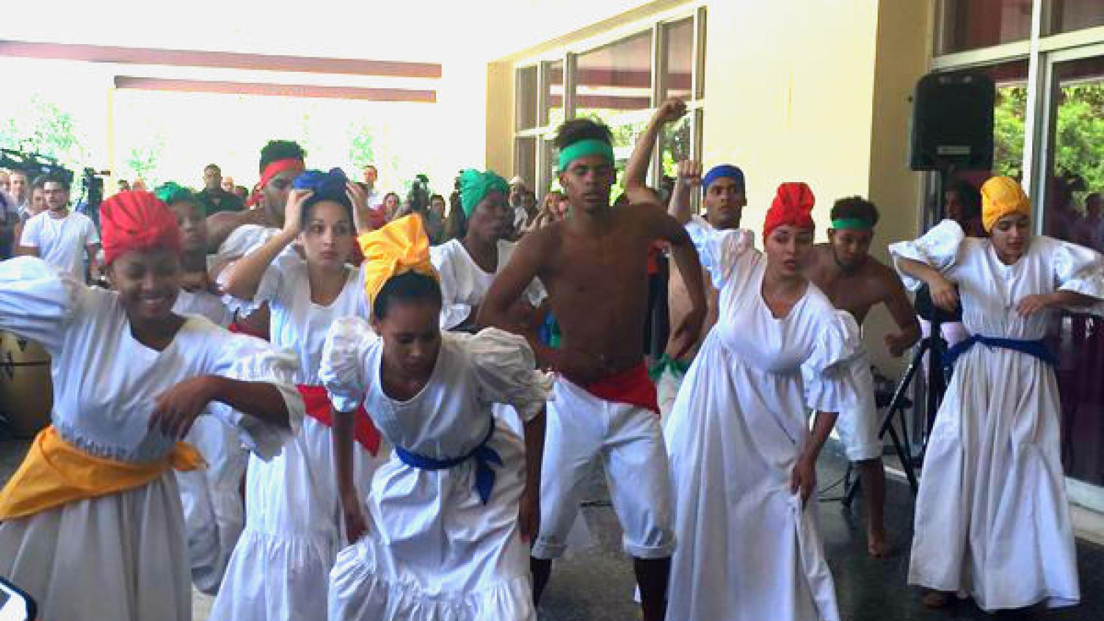 Dancers wearing white dresses and head scarves performing