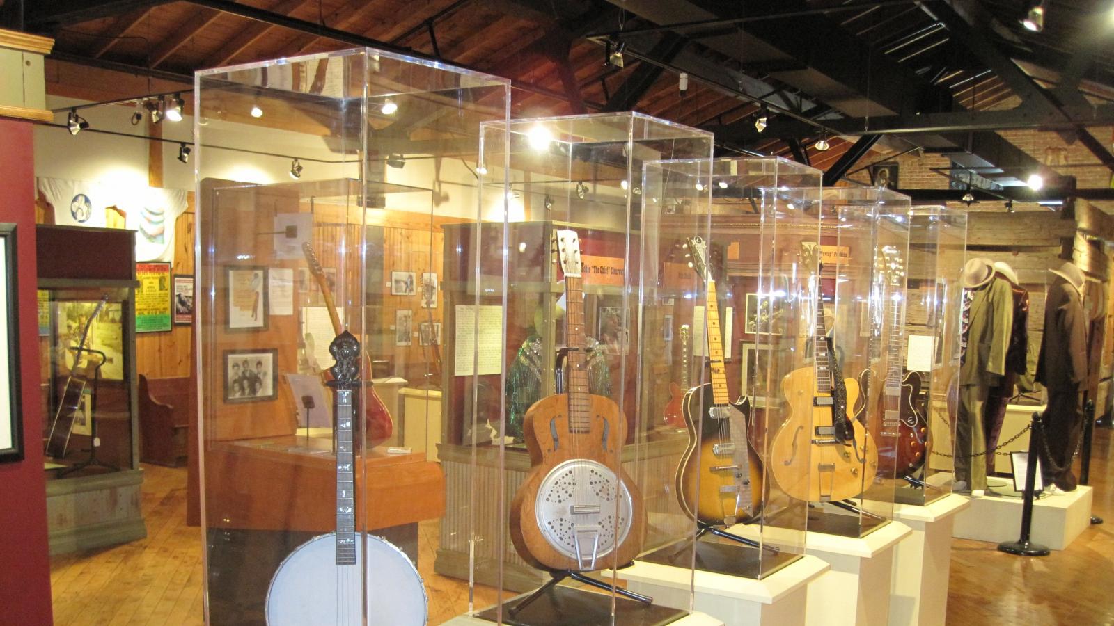 Instruments in glass cases inside a museum gallery. 