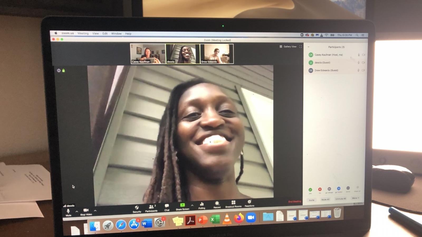 University of Tennessee Zoom call A laptop screen shows a video of a smiling woman with smaller pictures of the people she is speaking with above