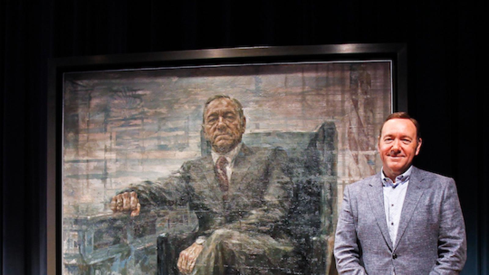 Actor Kevin Spacey stands next to a portrait of himself as TV character Frank Underwood