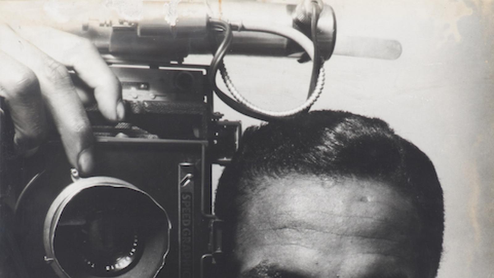 self-portrait of photographer Gordon Parks holding a camera