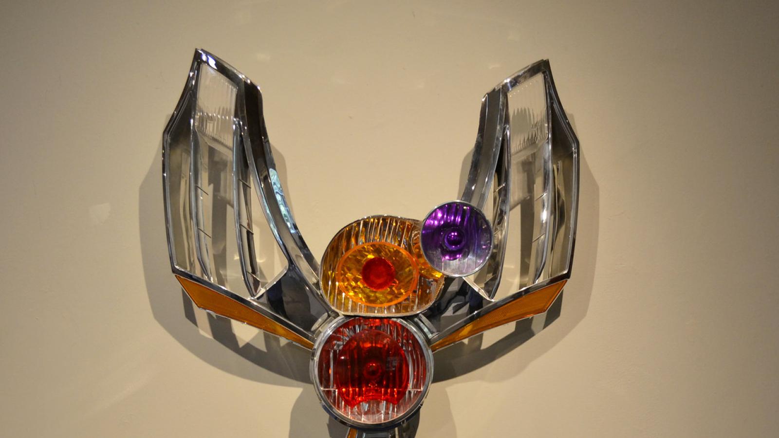 Phonix-like sculpture made of car fenders
