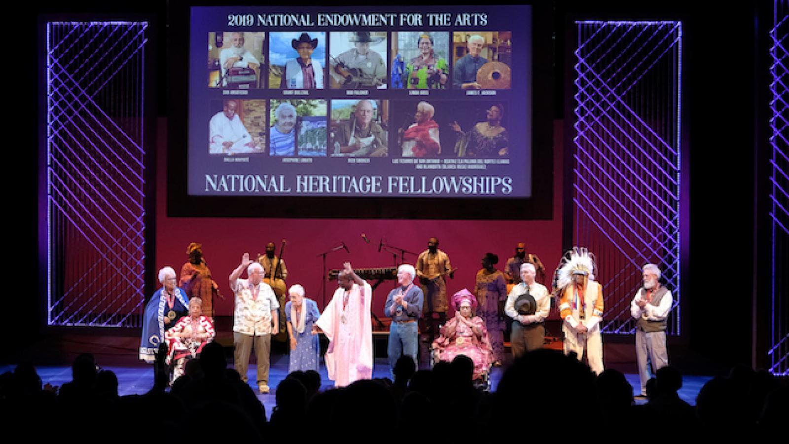 a group of diverse people on a lit stage