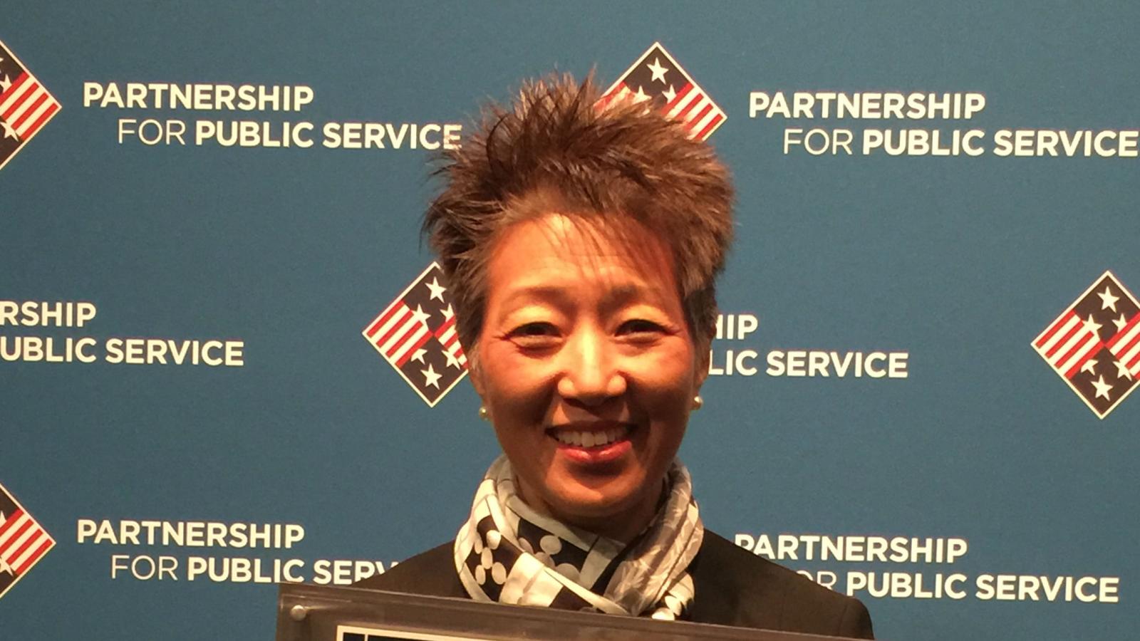 chairman chu holds an award plaque