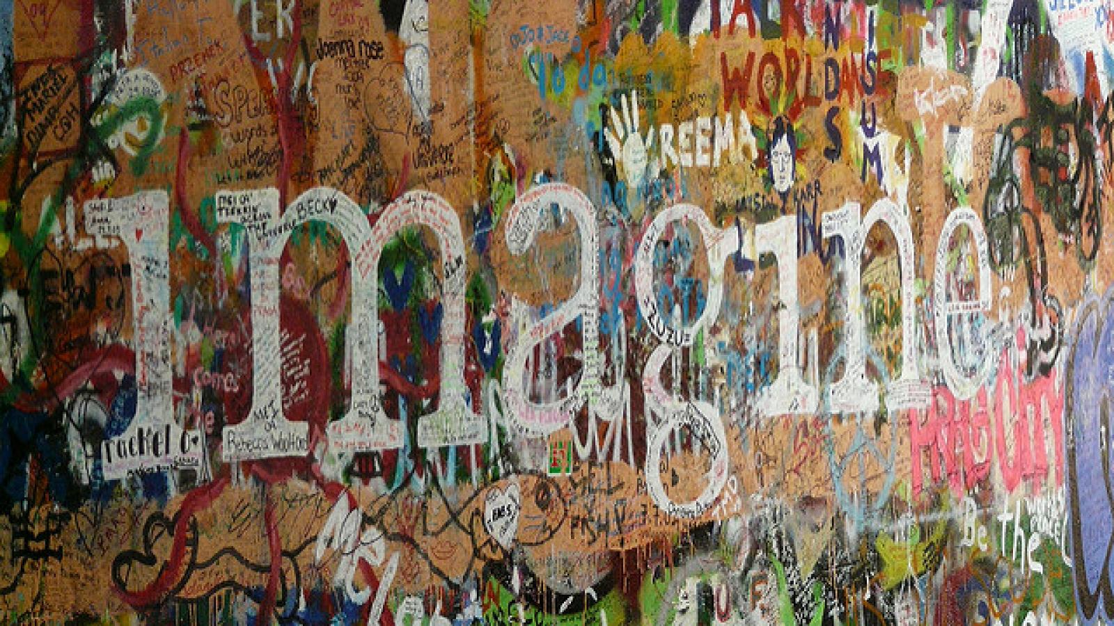 Word Imagine on wall with graffiti 