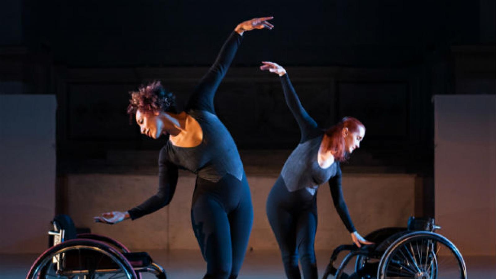 Two disabled dancers dancing with wheelchairs