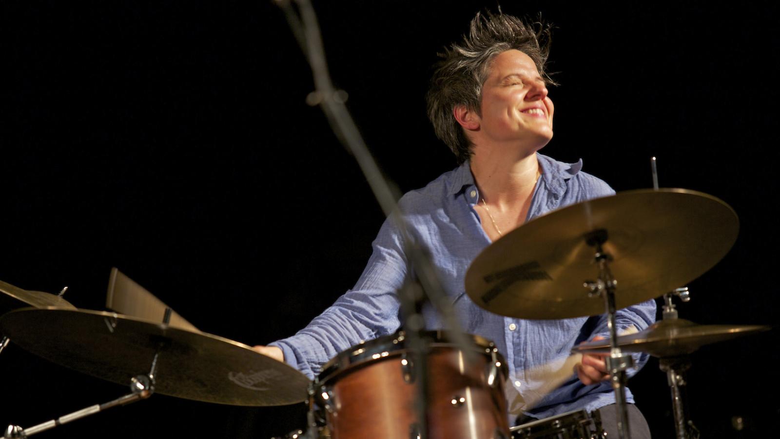 A woman playing the drums