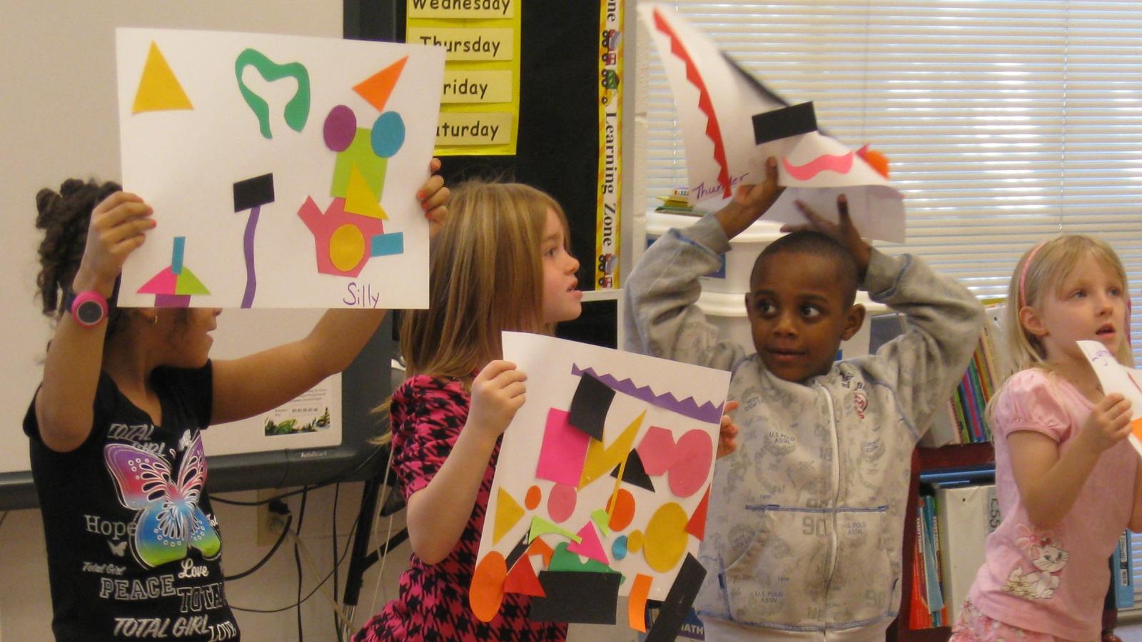 Children in school showing art work