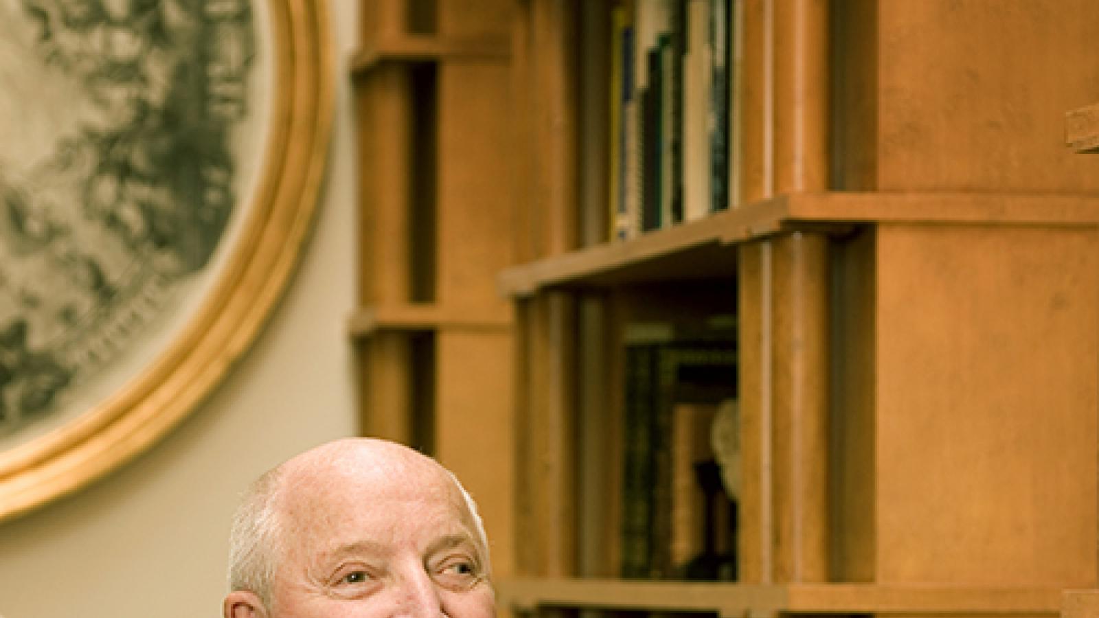 Michael Graves sitting with book in hands. 