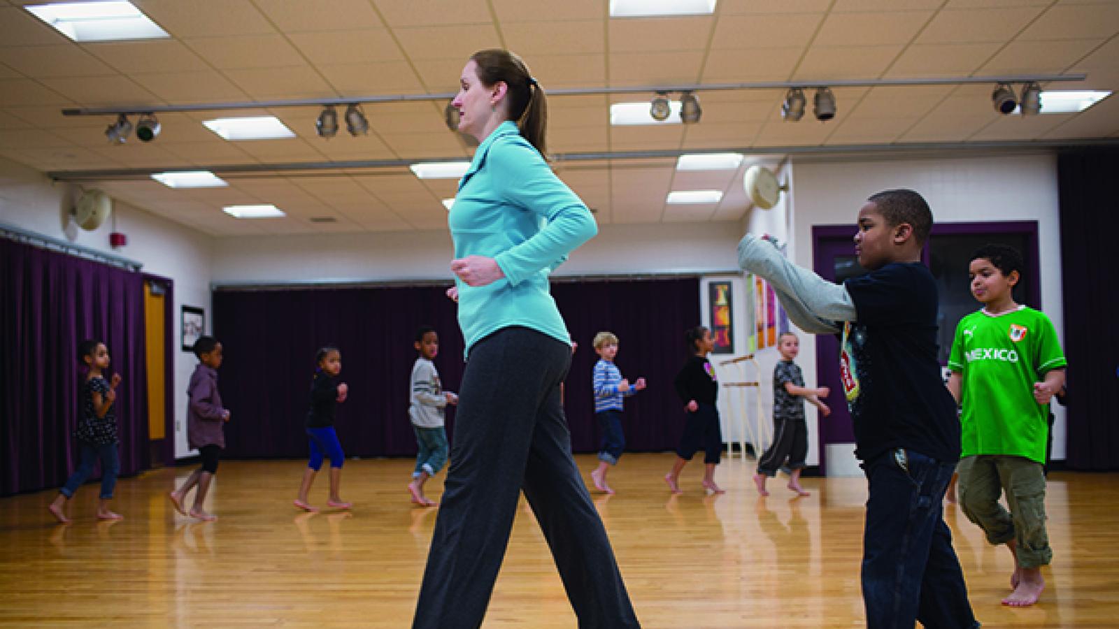 Woman teaching a dance class to young children