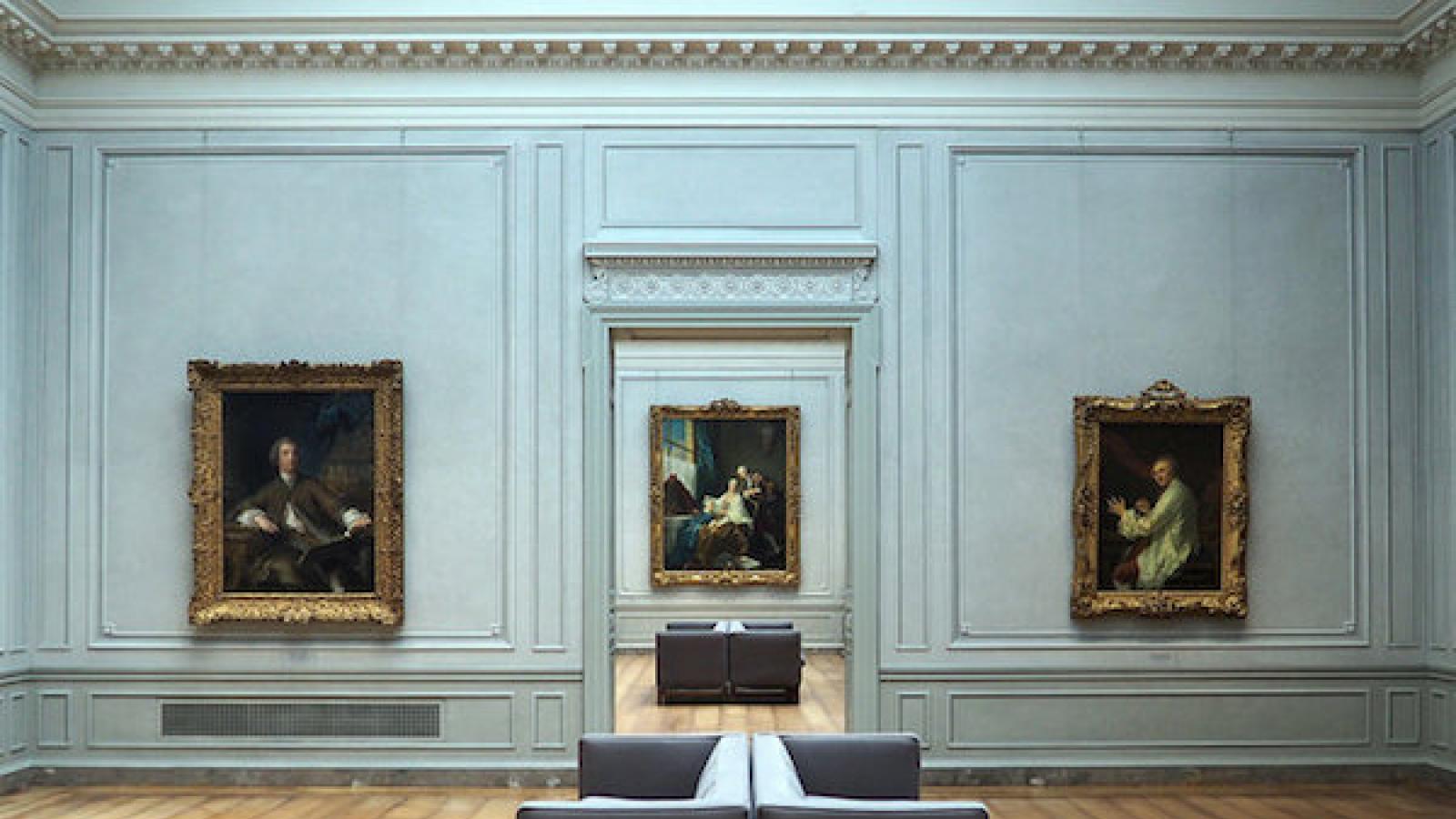 a blue-painted room at the National Gallery of Art in Washington, DC featuring several classic paintings