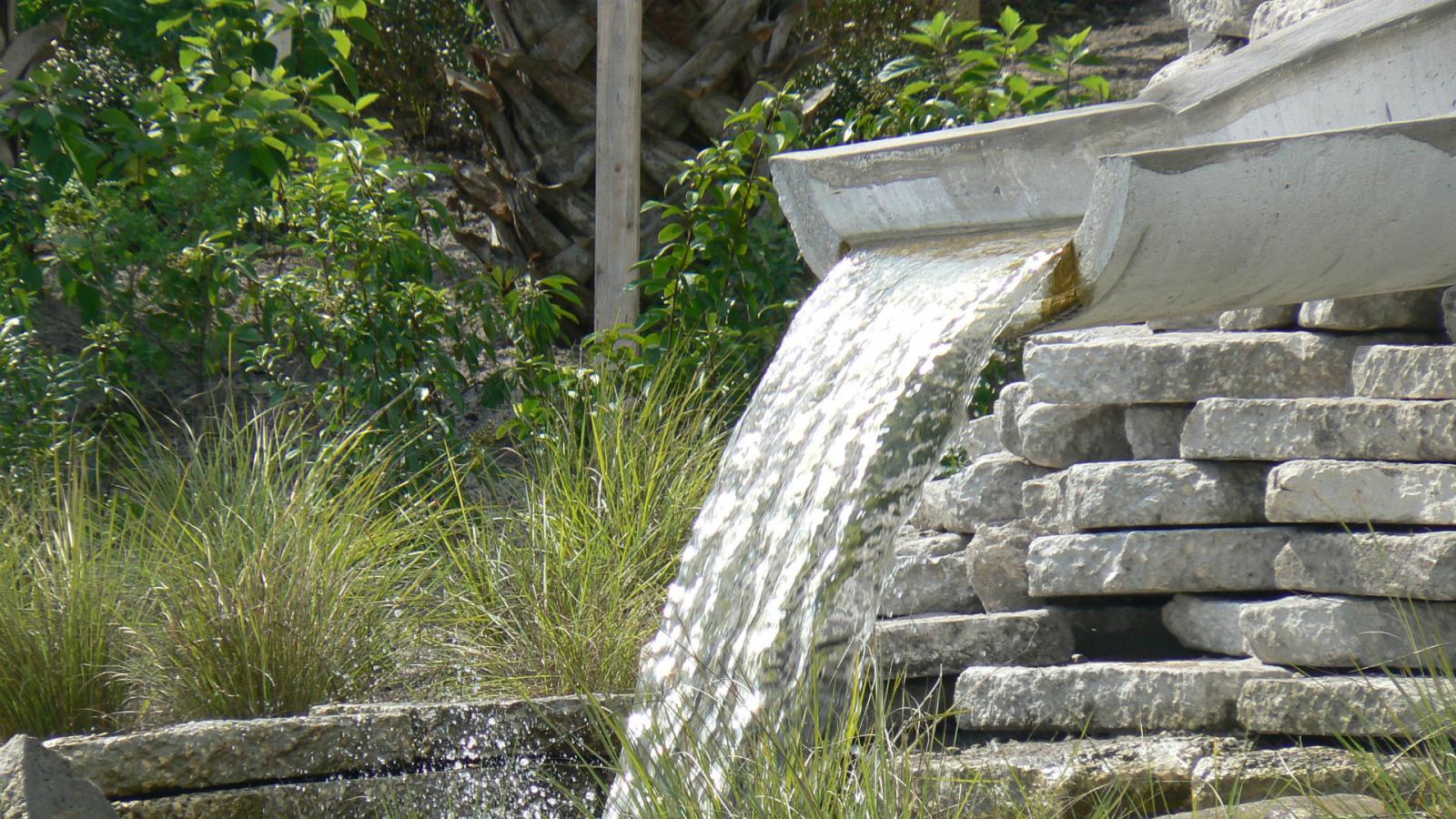 A fountain made of a cut stormwater pipe