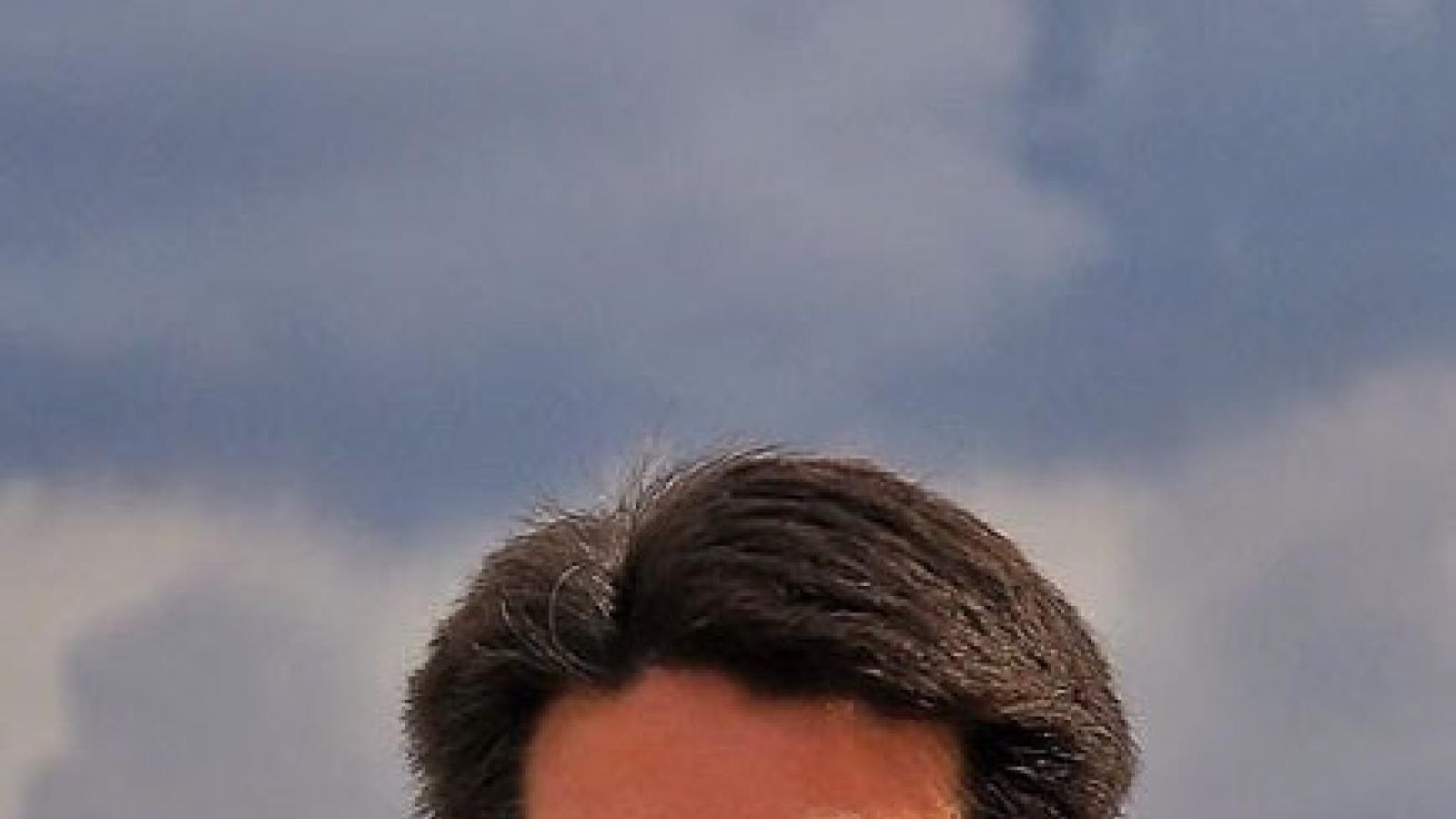 Headshot of with dark beard, mustache and glasses