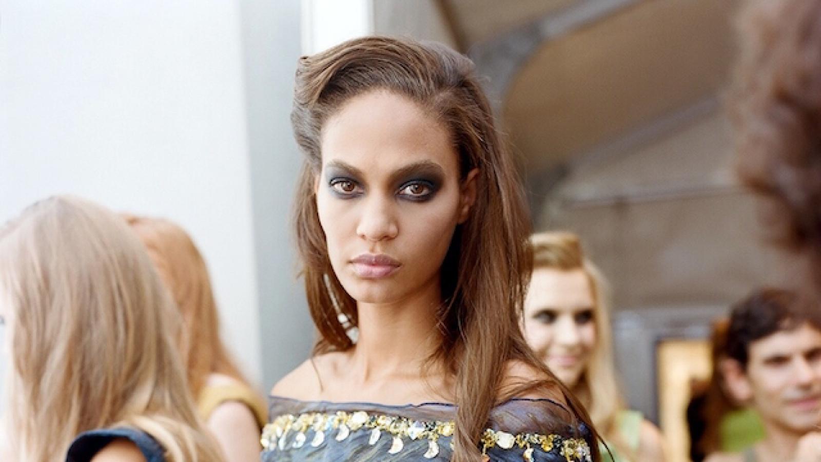a model wearing a blue patterned gown