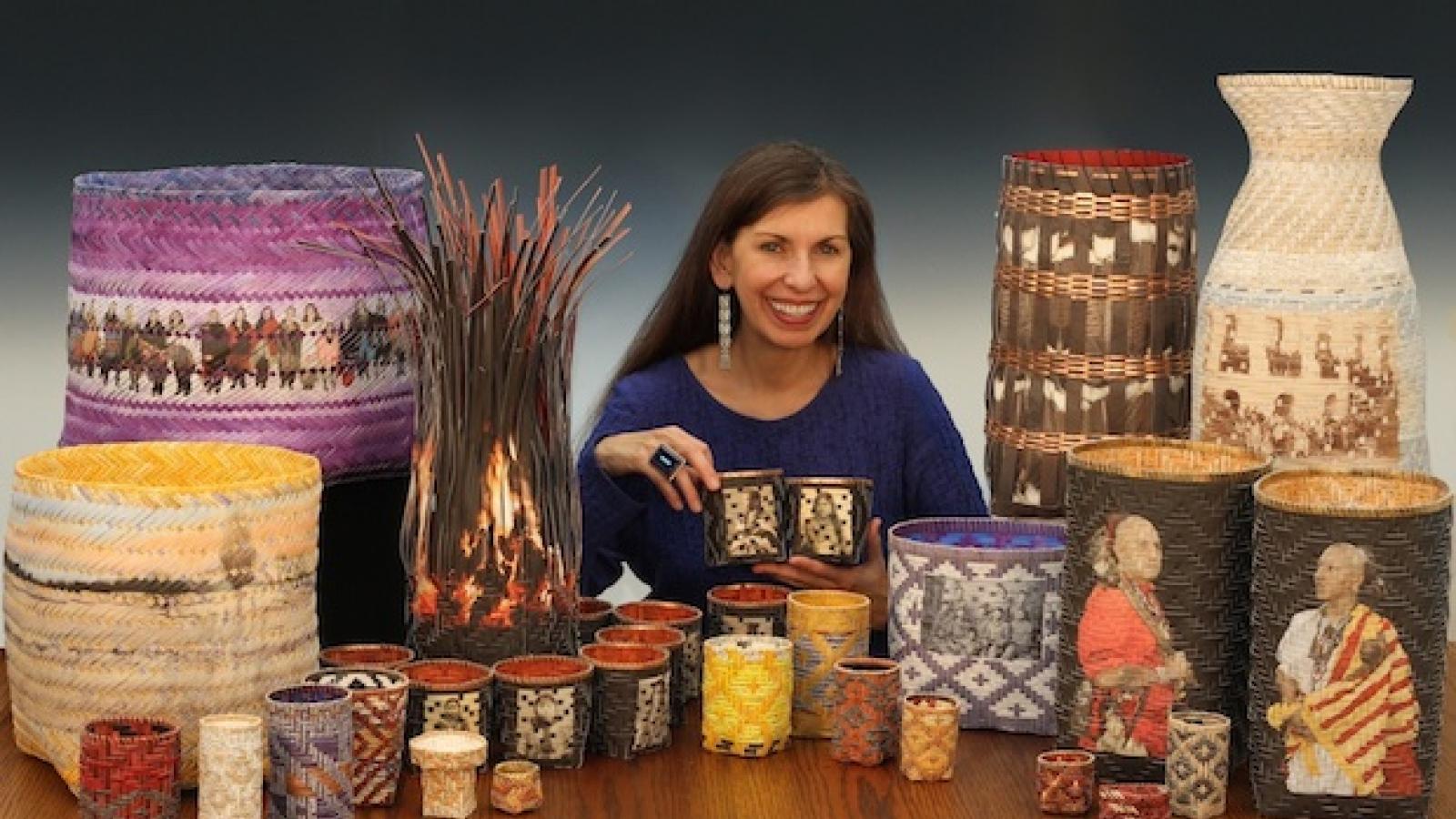 a native american woman with long dark hair surrounded by a selection of handwoven baskets featuring photographs and snippets of texts