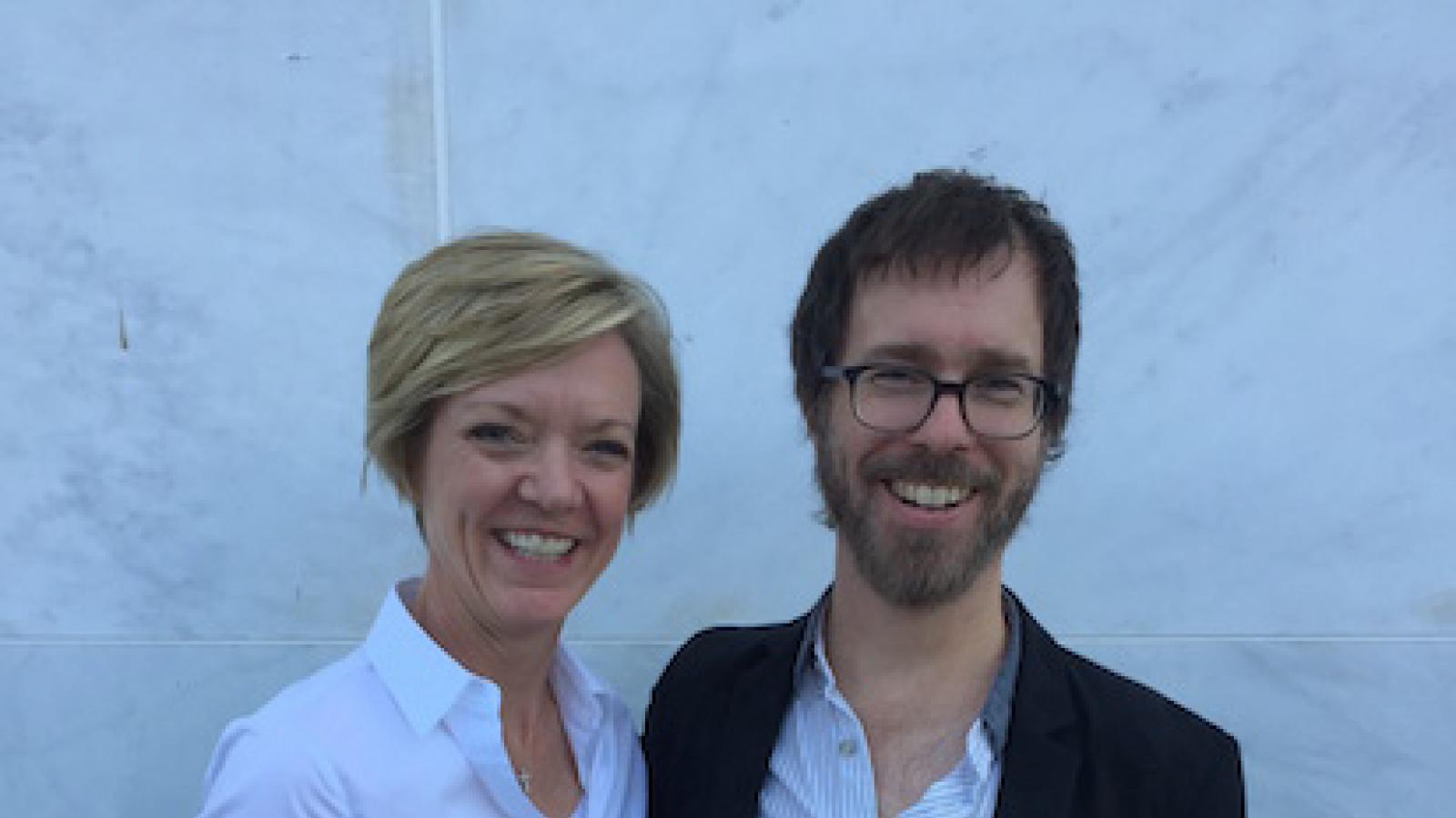 a white woman and a bearded white man with glasses