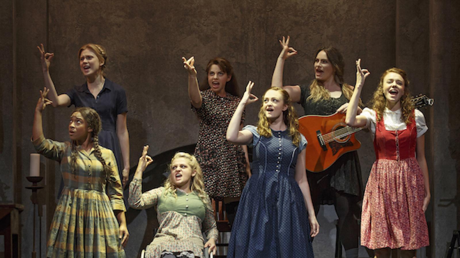 seven women onstage signing a scene from the play Spring Awakening