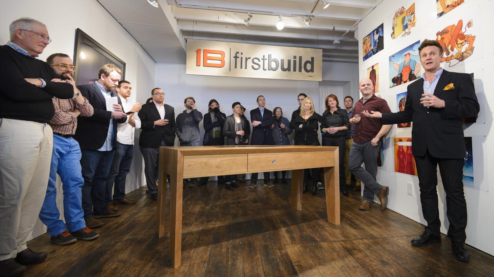 A group of people standing around a newly build table.