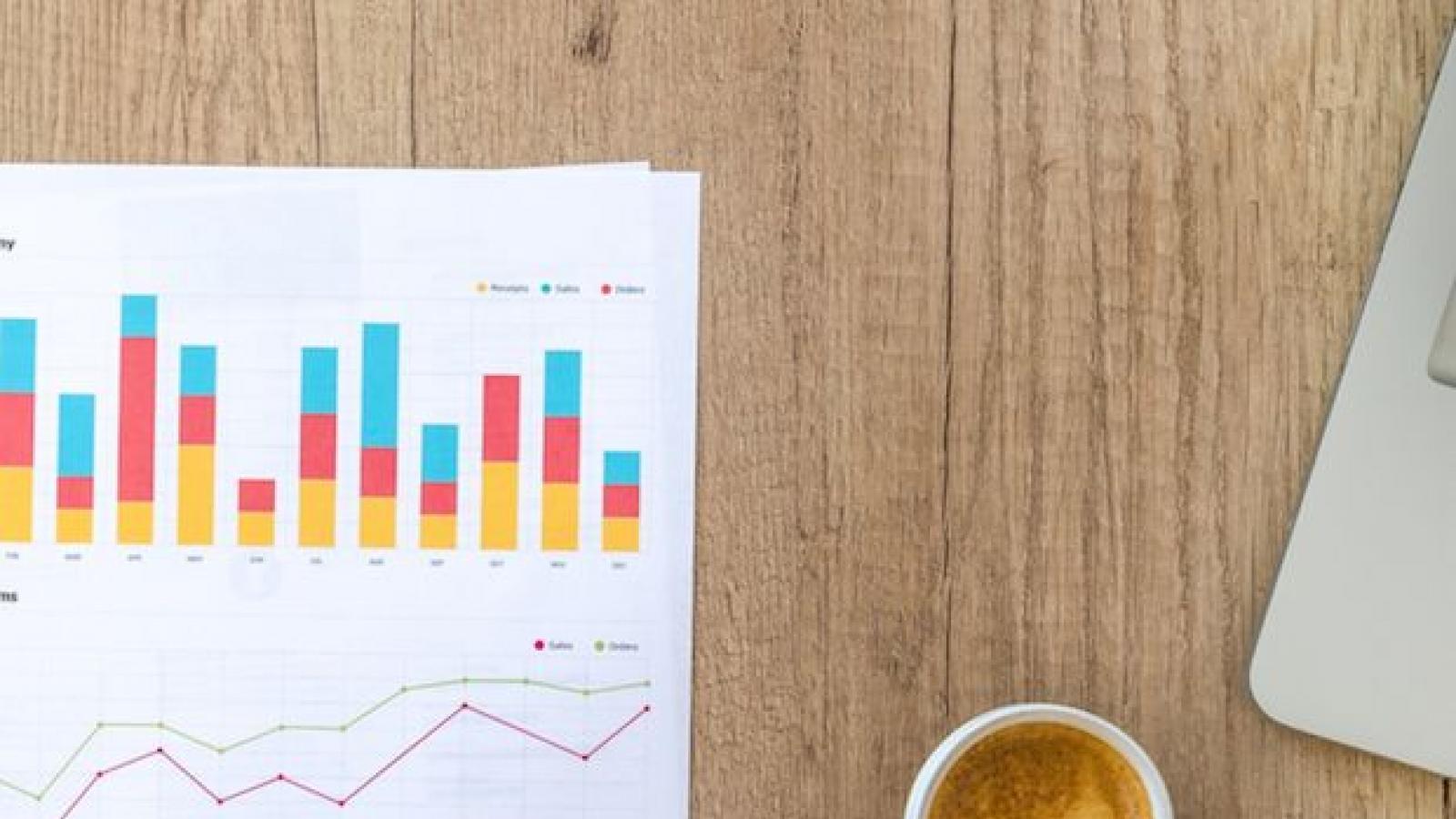 A coffee mug next to research chart