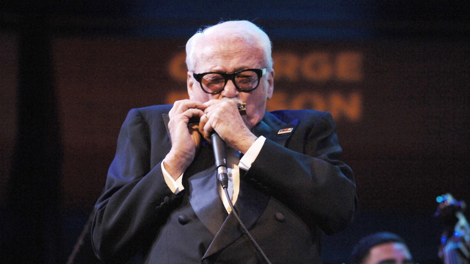 Toots Thielemans performs on the harmonica