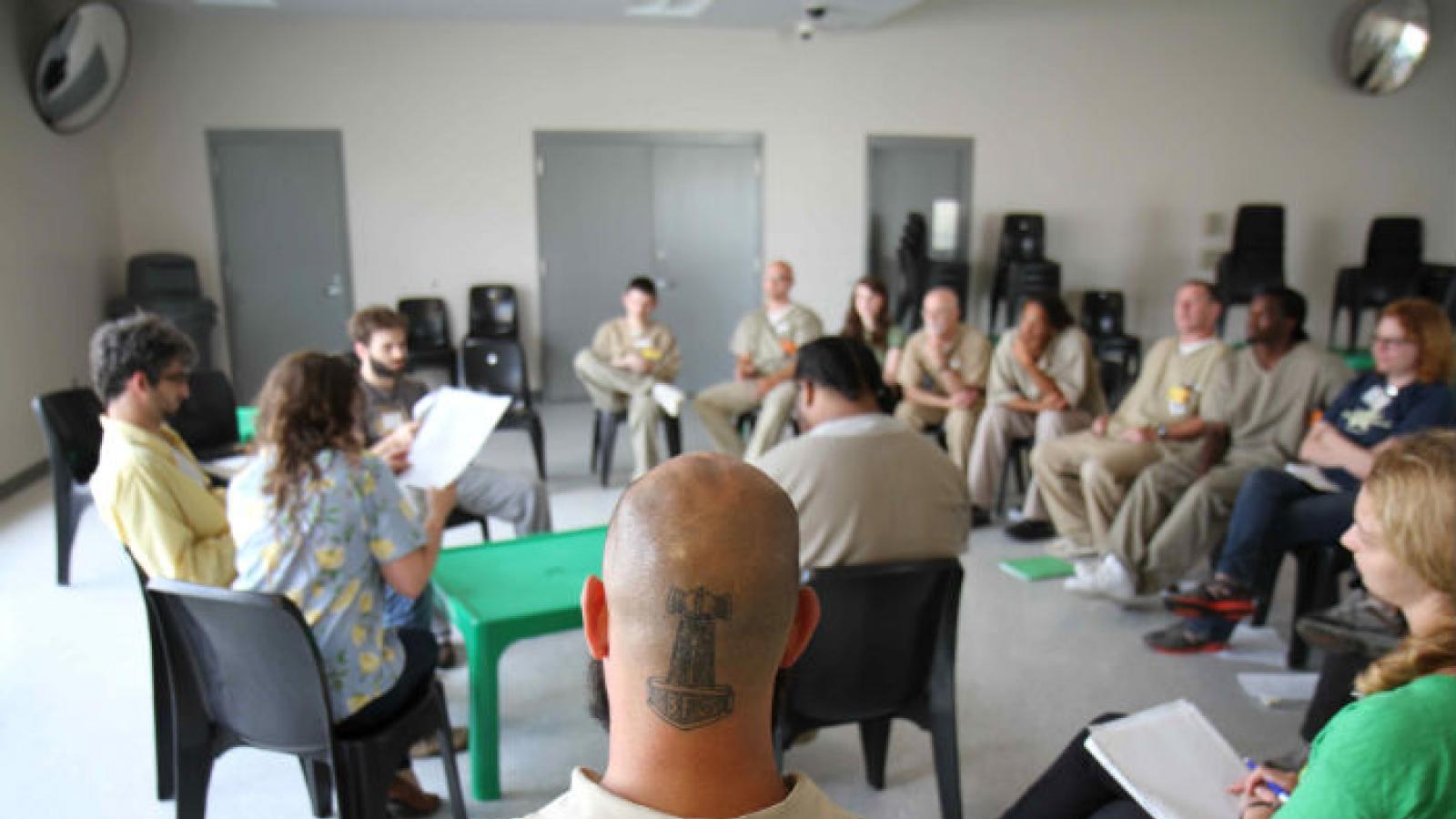 Group of prisoners reading scripts