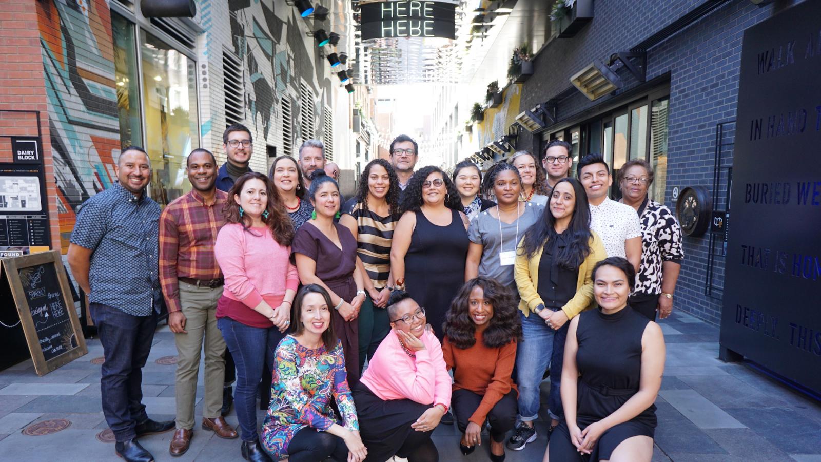 A group of people stand smiling at the camera