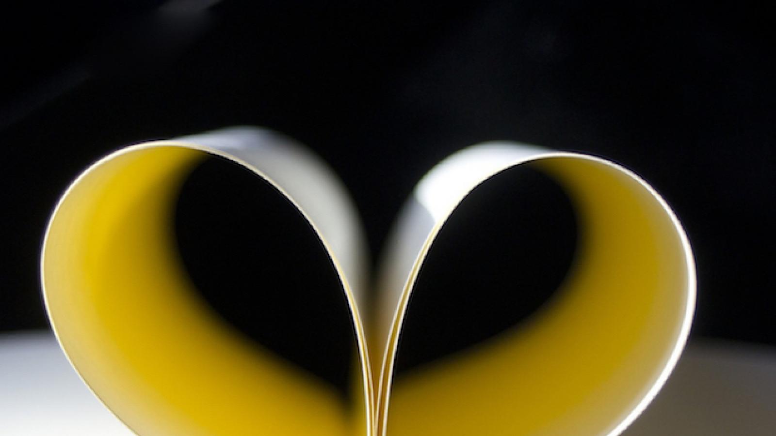 open book with pages folded into a heart with text Wisdom Wednesday National Poetry Month Edition