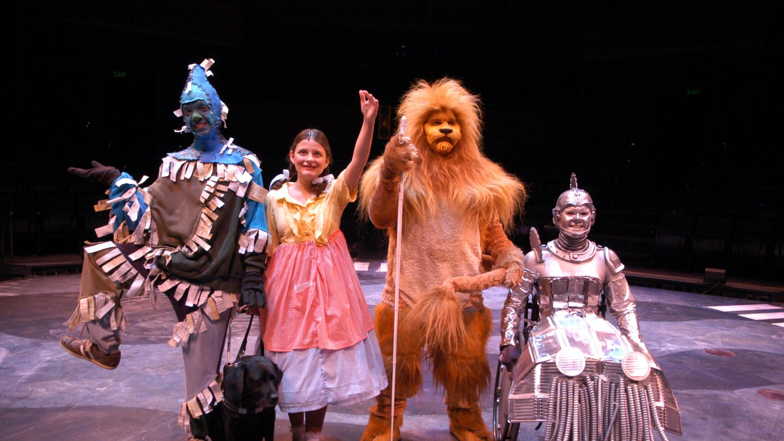 Four disabled performers dressed as Wizard of Oz characters