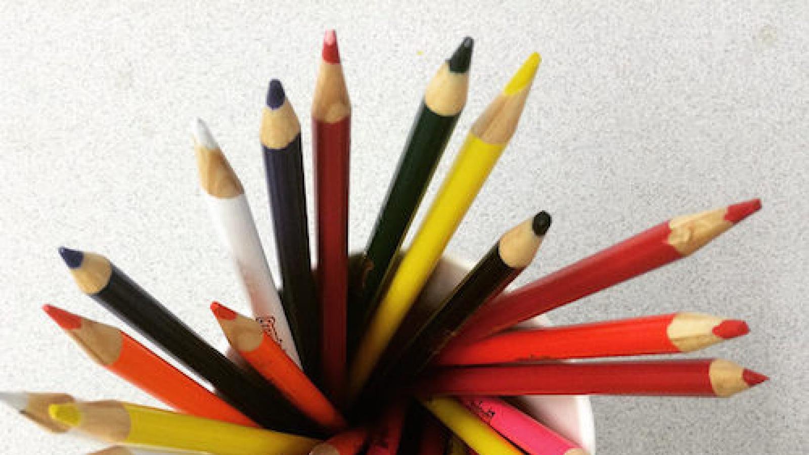 a cup of colored pencils point-side up