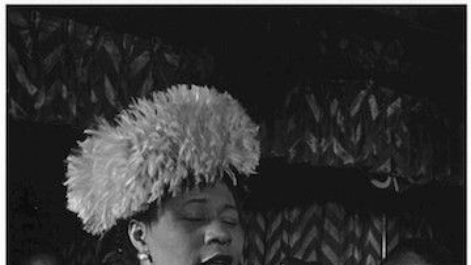 b/wimageofEllaFitzgeraldsingingwithDizzyGillespielookingon