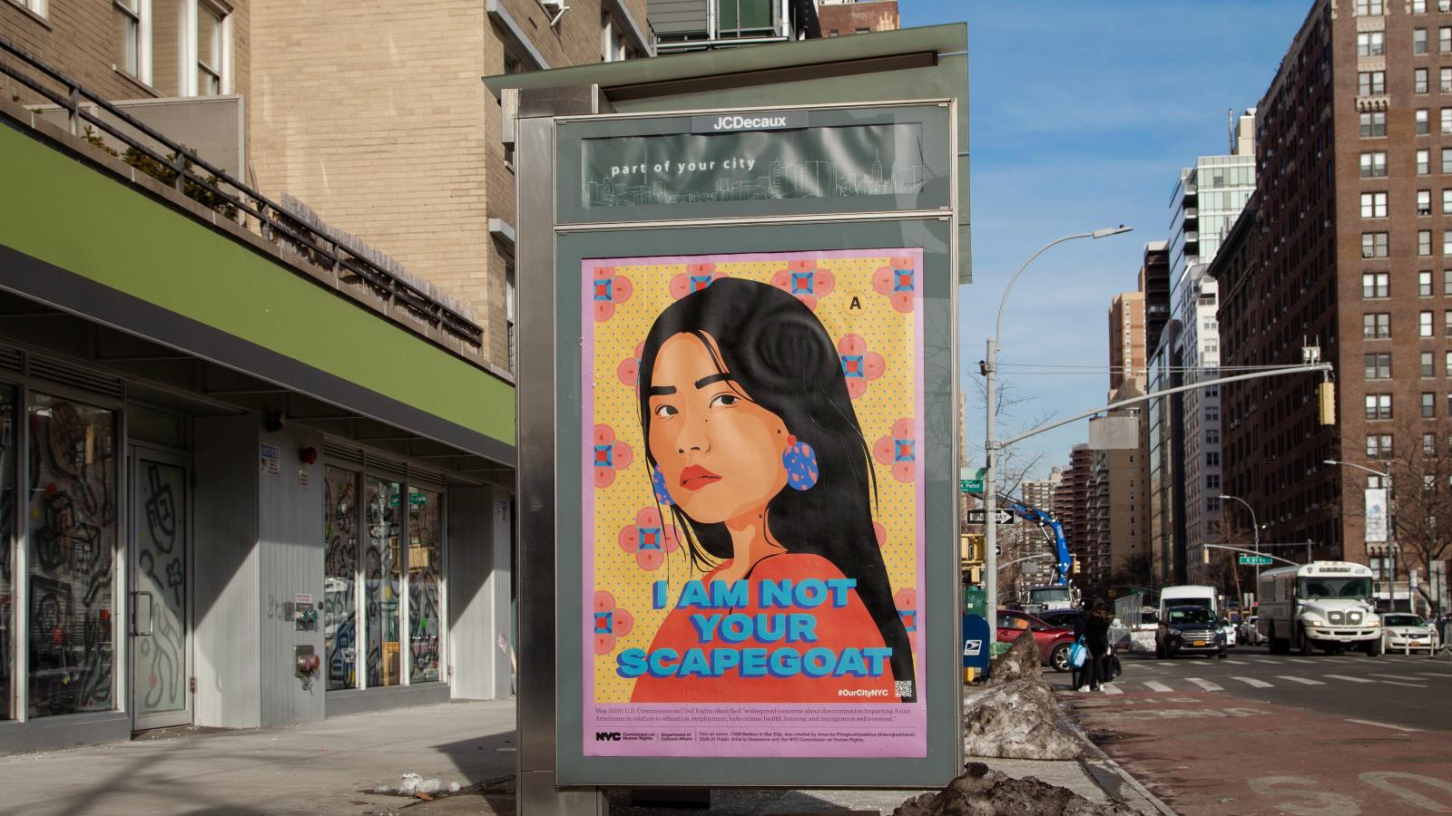 Colorful poster of Asian woman on a bus stop with the caption "I am not your scapegoat."