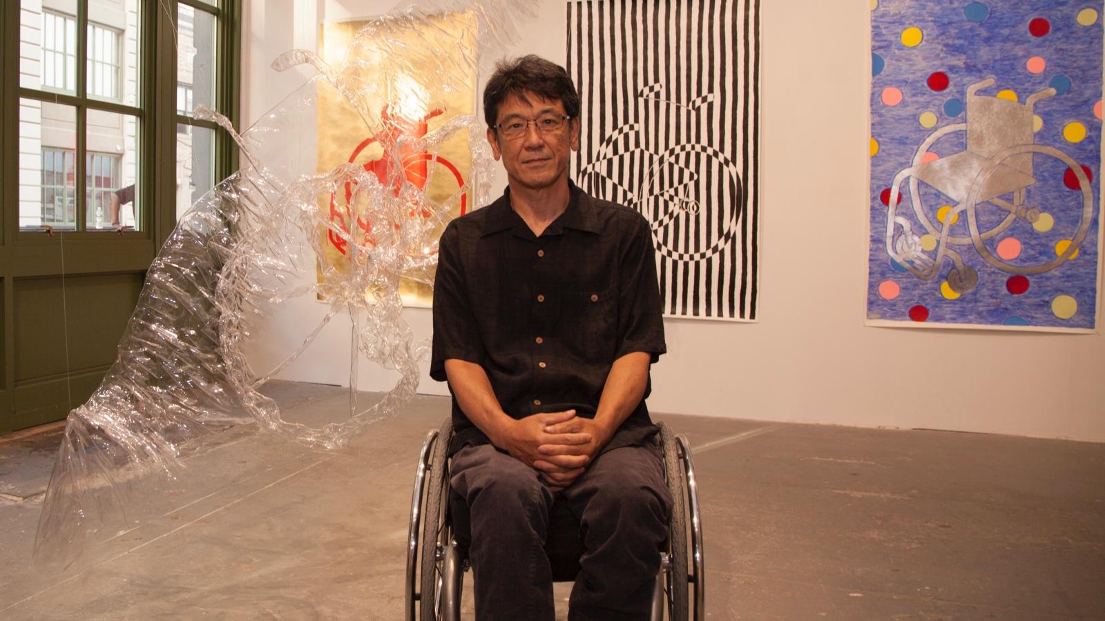 man in wheelchair in an art gallery.