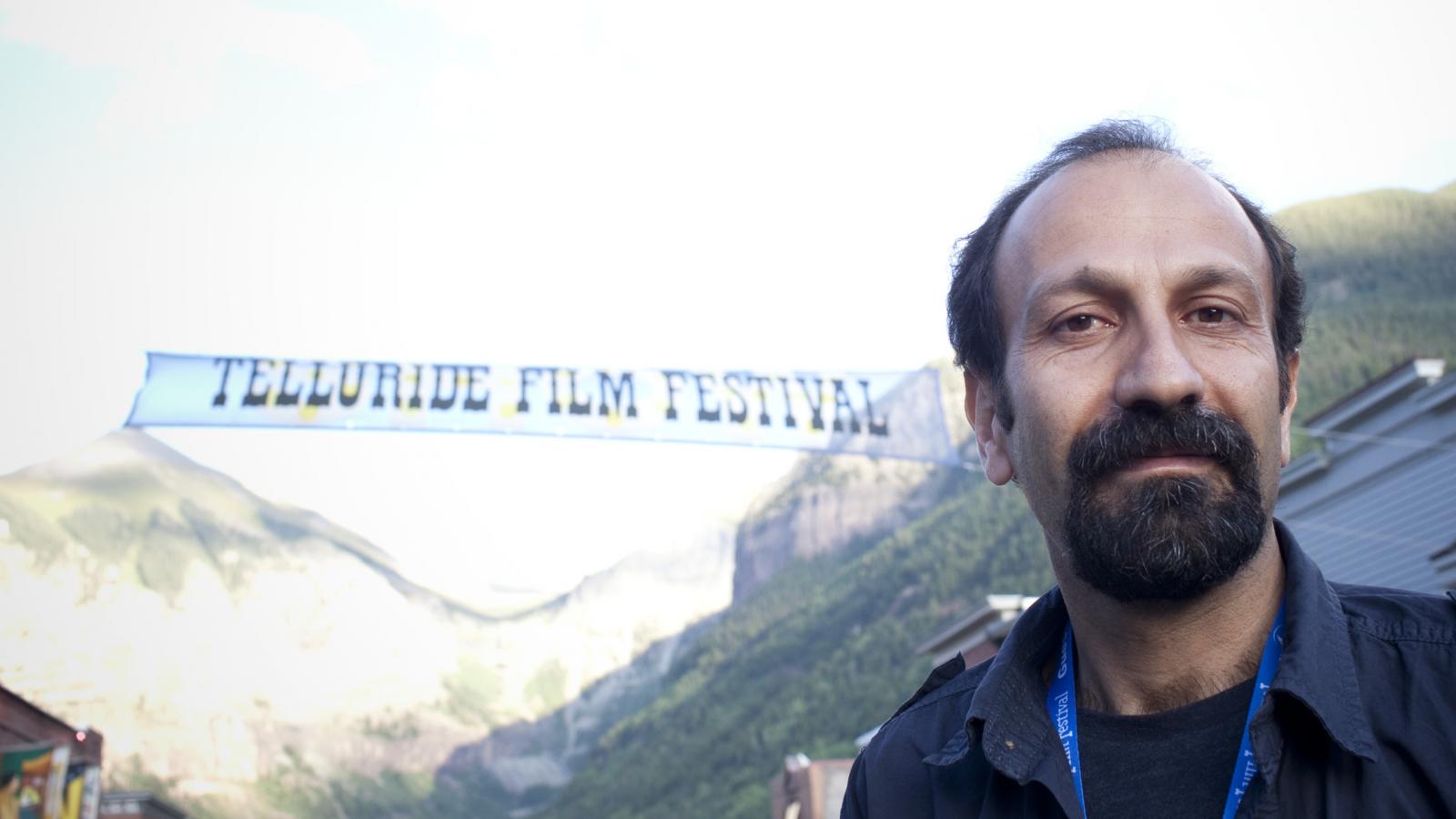 Man standing outdoors in front of a banner