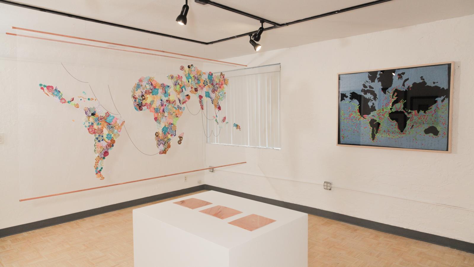 View of a museum exhibit showing various images of maps. 