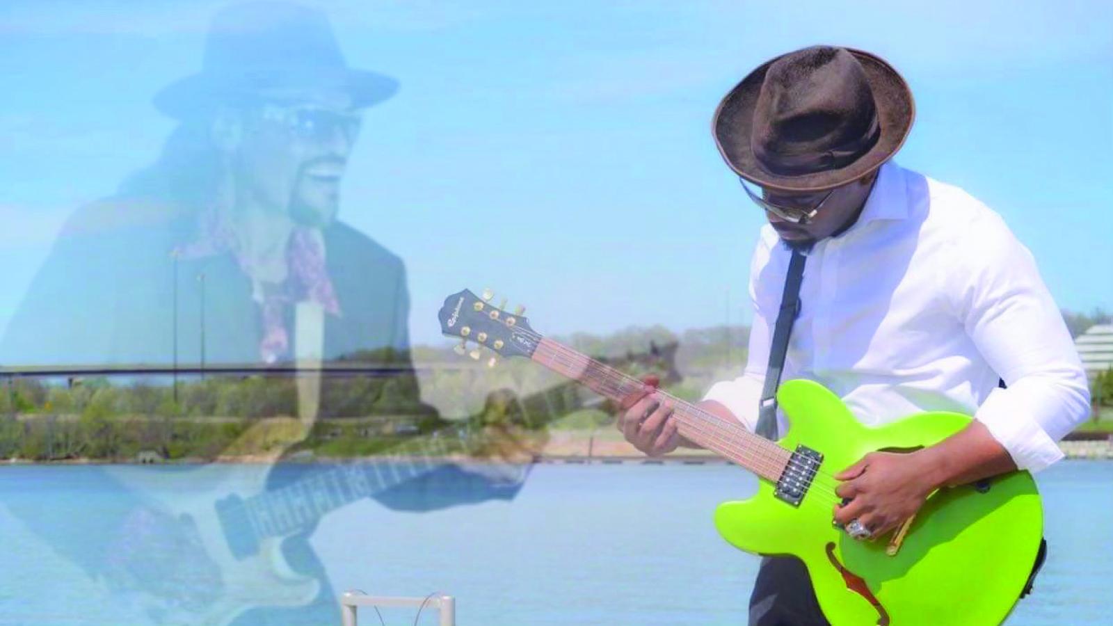 Faded image of guitarist with hat next to left-handed guitarist with green guitar also wearing hat.