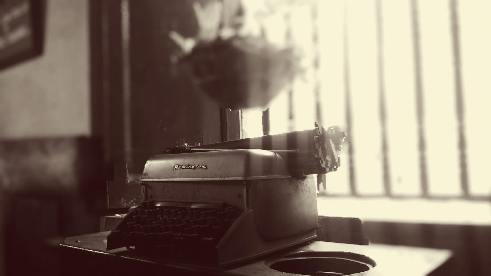 A typewriter sitting on a desk. 