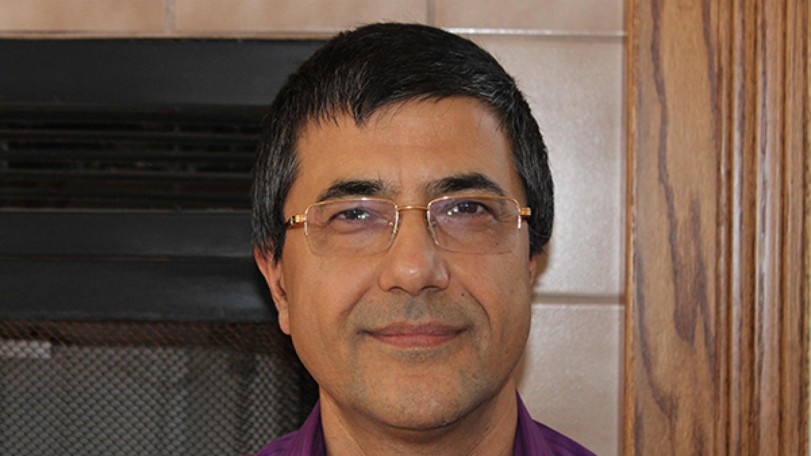 a Nepalese-American man with glasses