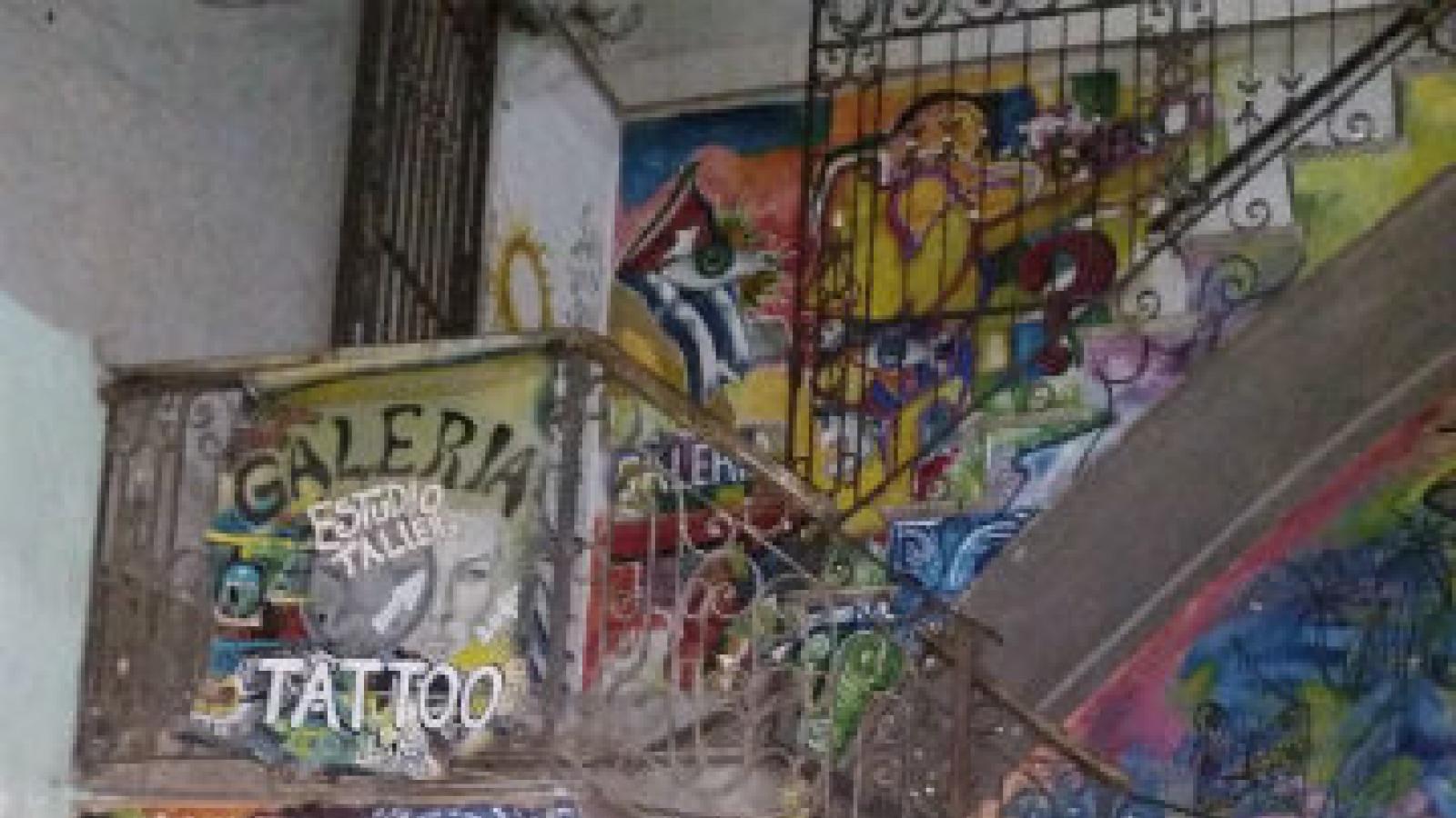 circular staircase in alley with brightly painted steps