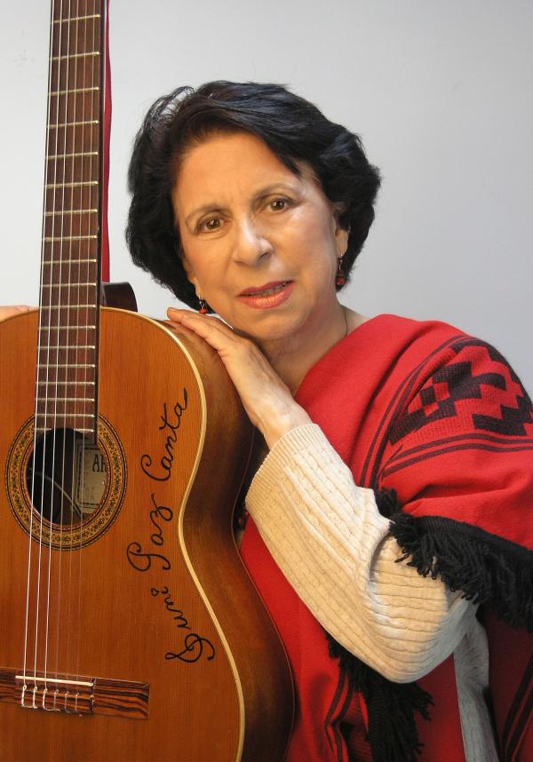 Woman holding a guitar. 