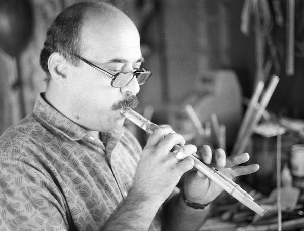 Man playing a flute.