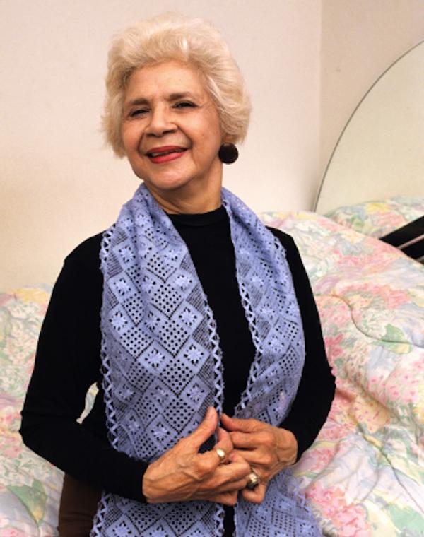 Photo of a woman showing a knityted shawl.