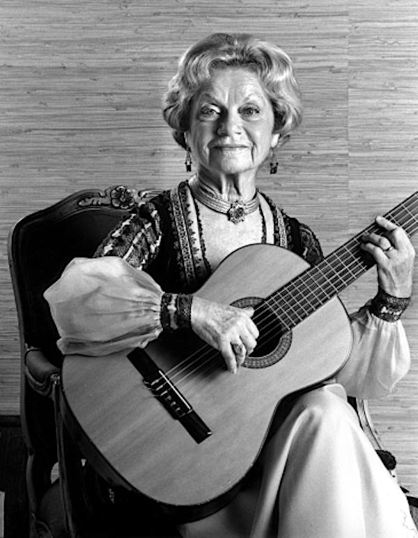 A woman playing the guitar.