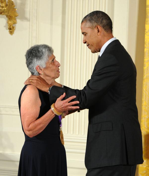 Joan Harris receiving an award from Barack Obama