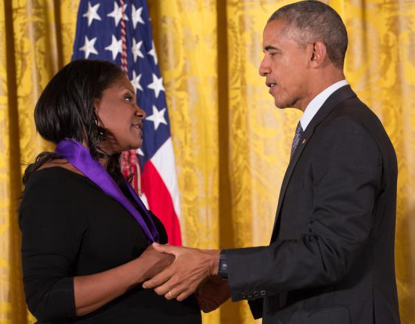 A man and a woman shake hands.