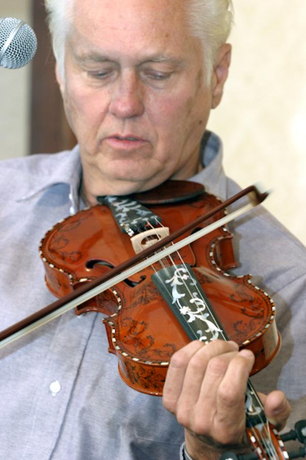 A man playing a fiddle.