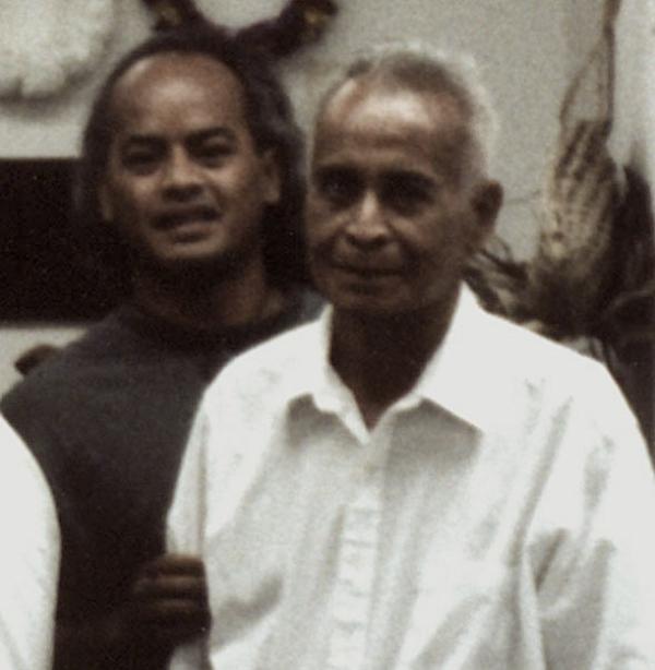 Two men pose for the camera.