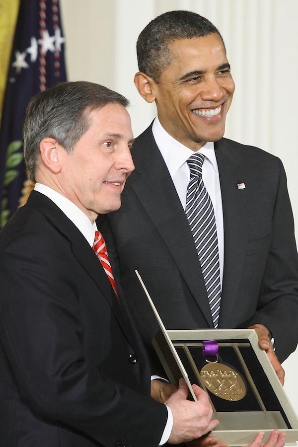 Two men look to one side.