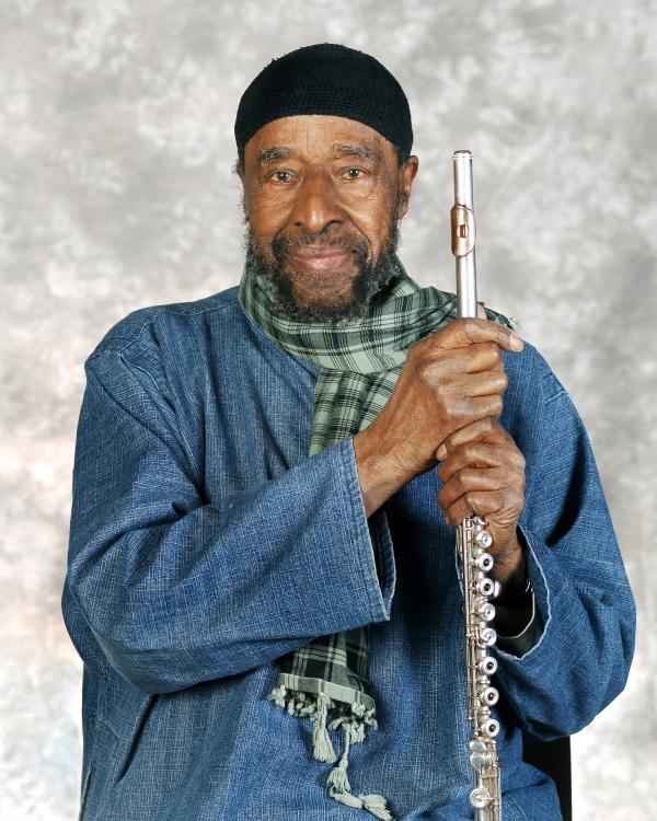 Portrait of man holding flute. 