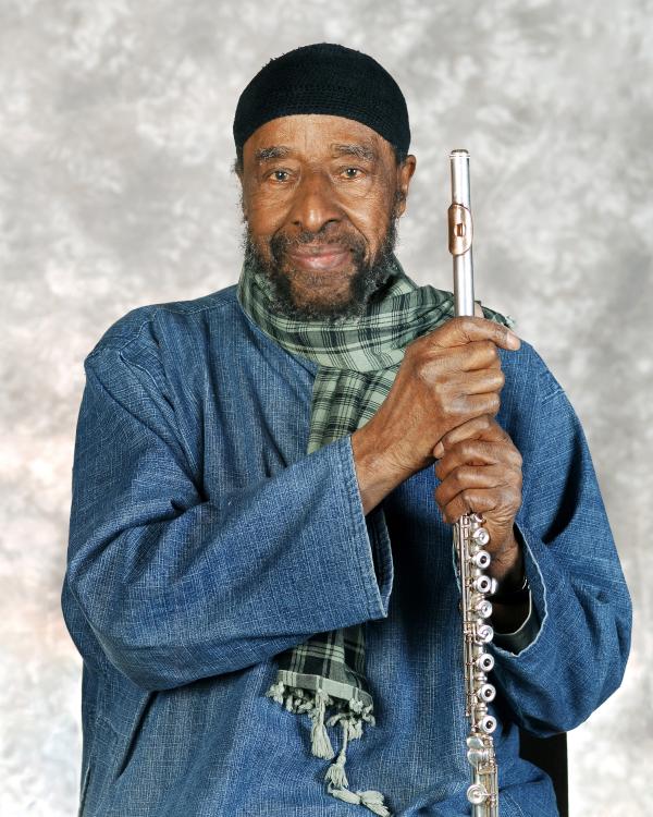 Portrait of man holding flute.