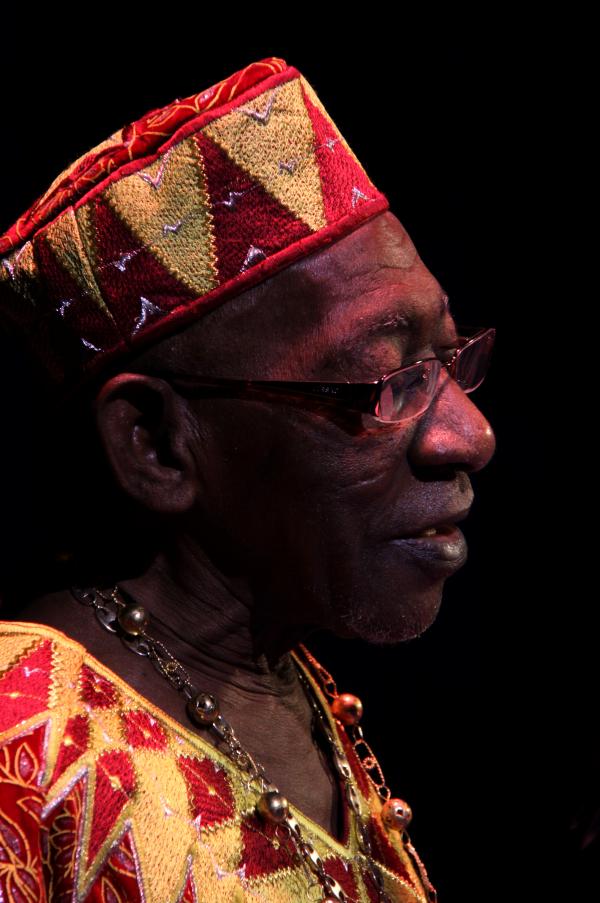 Man in African garb on stage.
